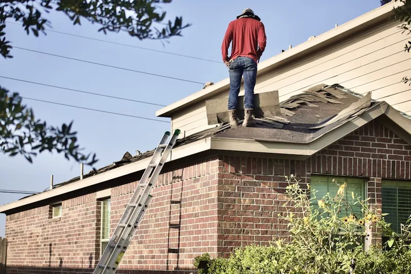 Professional roofer working on a residential roof in Lee Acres